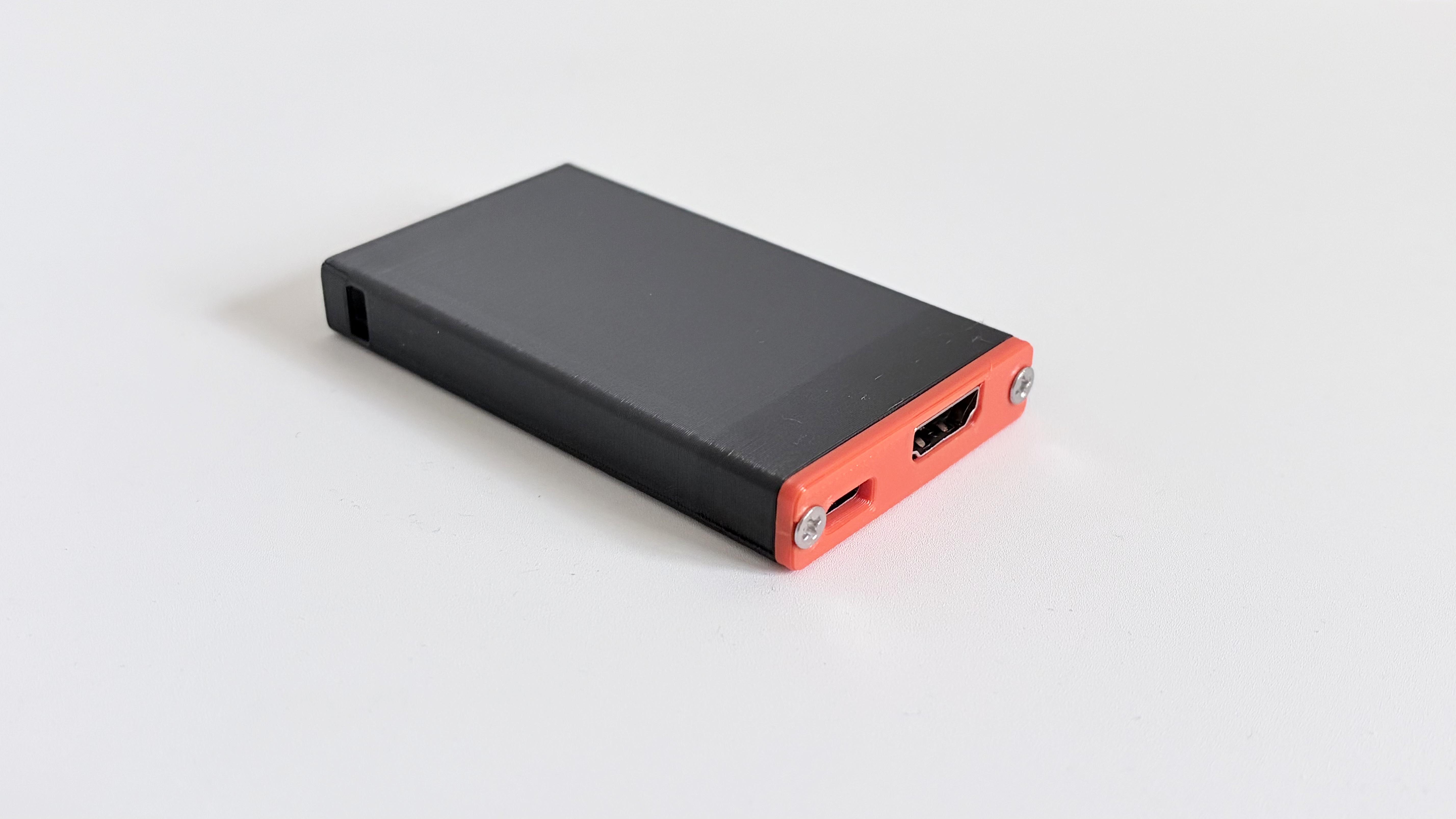 DezKVM-Go device showing HDMI and USB-C ports on the red end cap